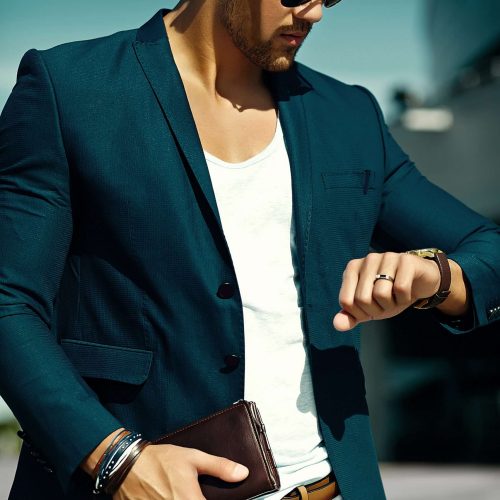 Fashion portrait of young sexy businessman handsome  model man in casual cloth suit in sunglasses in the street